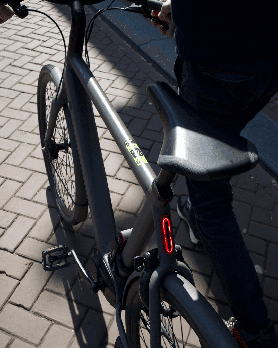 Yellow BIKEBAZE SafeTag sticker on silver frame tube of modern bike in sunlight.